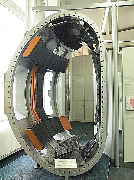 A large circular object with black seats

AI-generated content may be incorrect.